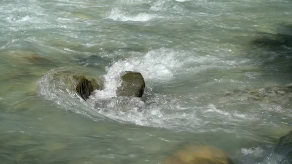 Rapid mountain stream close-up alt