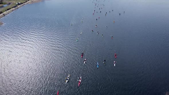 Birds Eye View of People Standing on a Bridge and Encouraging Canoers alt