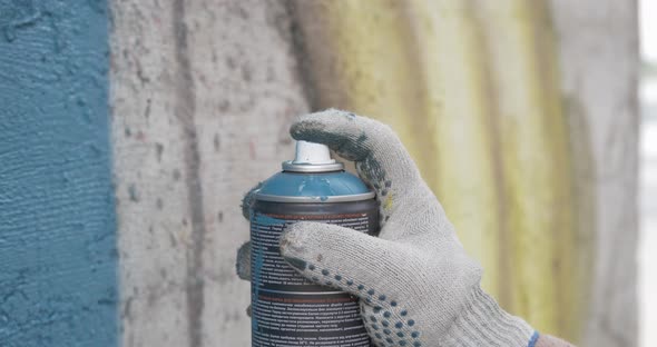 Graffiti Artist Hands with Paint Cans