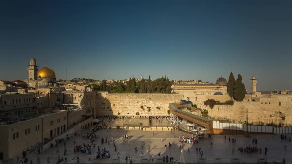 People on a beautiful evening pray near the Western Wall in Jerusalem, Israel alt