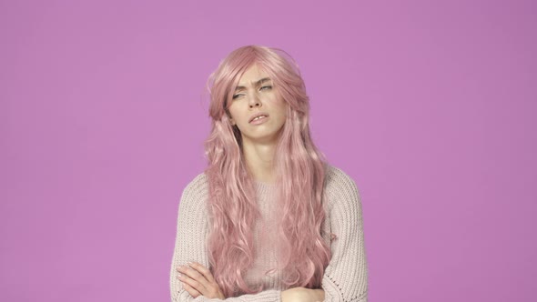 Impatient and Reluctant Young Bothered Cute European Teenage Girl in Pink Wig Cross Hands Over Chest alt