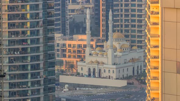 Al Raheem Mosque Between Skyscrapers Timelapse on the Marina Walk in Dubai Marina Dubai UAE alt