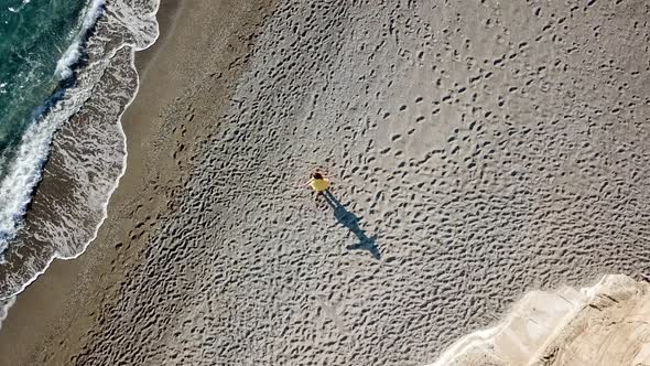 Aerial Drone Footage of a Girl Dancing at a Lonely Beach