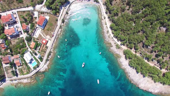 Aerial view of people swimming in turquoise bay on the island of Brac, Croatia alt