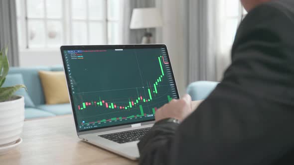 Asian Businessman Happy After Seeing Uptrend In The Trading On Computer Screen While Working At Home alt