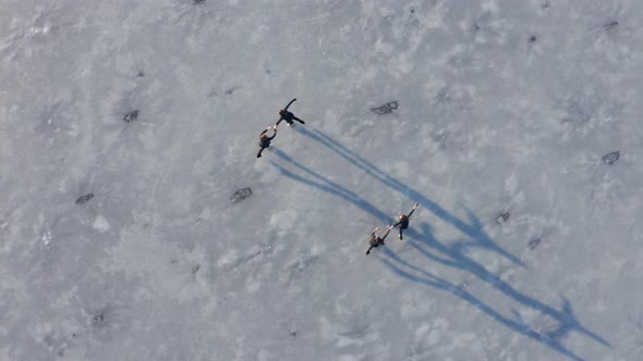 Four young women figure skating on frozen alt