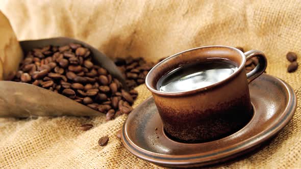 Black coffee, roasted beans and scoop on sack alt