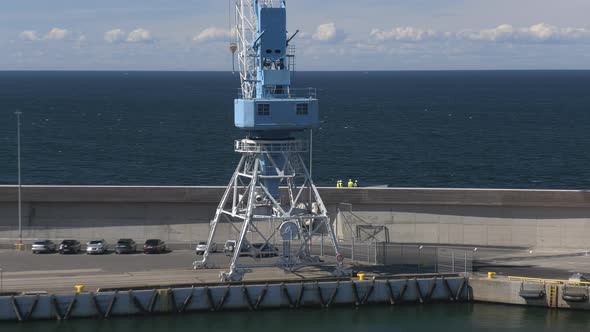 Awesome Shot of Construction Workers and a Big Crane at the Harbor of Tallinn alt