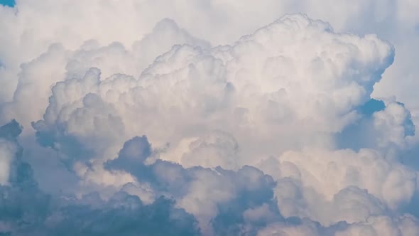 Timelapse of White Puffy Cumulus Clouds Forming on Summer Blue Sky alt