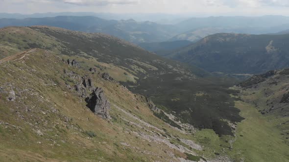 Scenic View of Valley Between Mountains alt