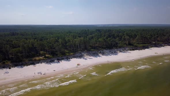 Baltic Sea beach aerial shot. Beautiful, secluded beach on Baltic Sea coast. Backwards flight and ca alt