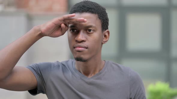 Portrait of Curious Young African Man Searching for Opportunities  alt