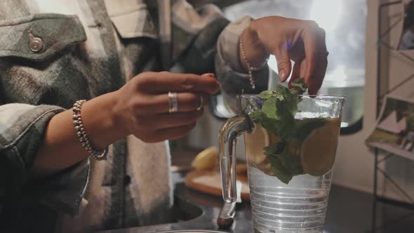 Woman Making Refreshing Drink in Camper alt
