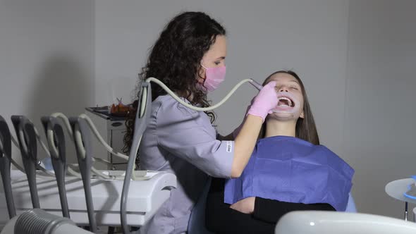 Dentist examine and treat spoiled teeth with the use of special dental instruments alt