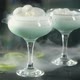 smoke slides onto the table from cocktail glasses with a blue drink - VideoHive Item for Sale