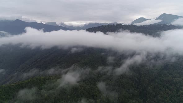 Aerial Drone Flying Over The High Mountains In Beautiful Clouds