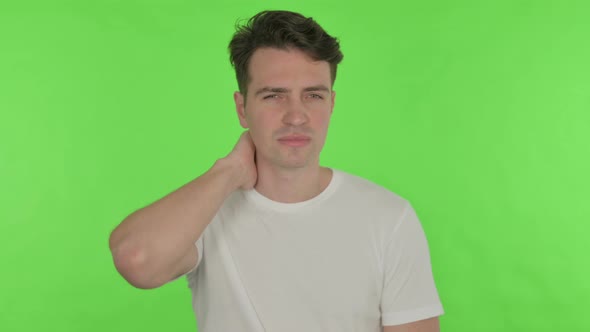 Young Man with Neck Pain on Green Background alt