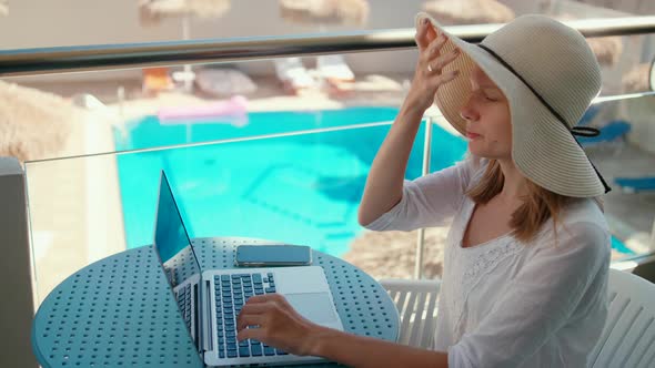 Woman Talks Online Using Laptop in Hotel on Summer Holiday or Vacation