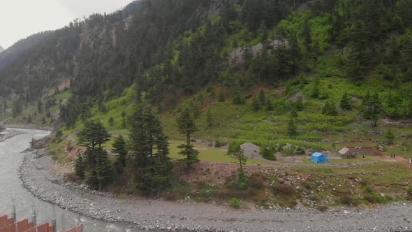 Aerial Over Swat River With Campsite On Riverbank In Kalam Valley In Pakistan. Dolly Forward alt