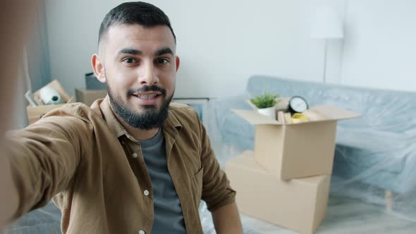 POV of Arab Man Making Online Video Call Talking and Showing House Key in New Apartment alt
