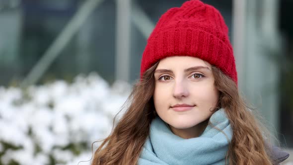 Close up Cute Face Portrait Serious Woman With Red Hat Look at Camera at City Center 