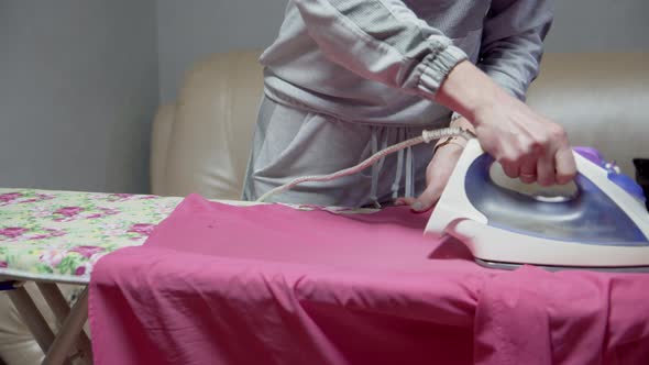 Housewife Woman Ironing Linen on Ironing Board