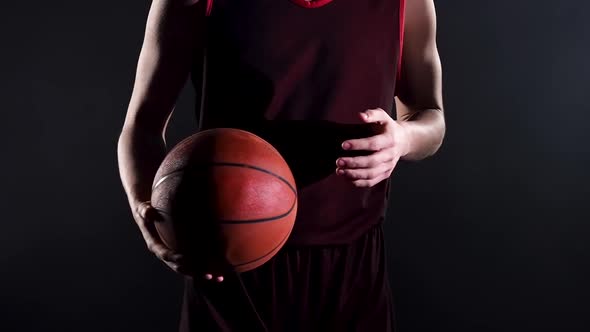 Young Basketball Player in a Dark Studio on a Black Background alt