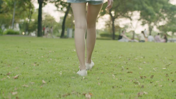 A beautiful Asian woman closed her eyes enjoying the breeze in the public park.