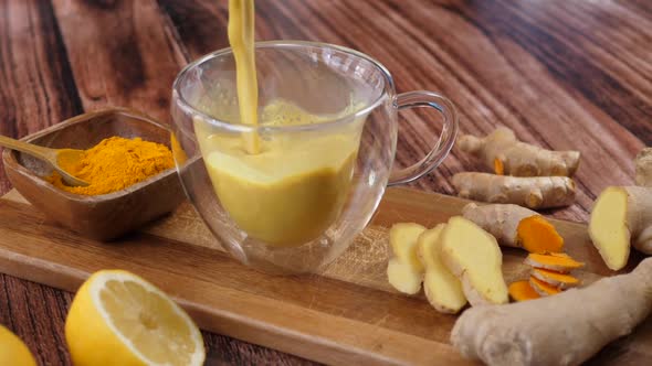 Immunity Boosting Antivirus Drink. Healthy Turmeric Latte Drink In A Glass Cup.  alt