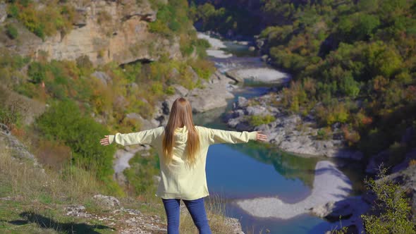 A Handheld Shot of a Young Woman That is Visiting the Moracica River Canyon in Montenegro alt