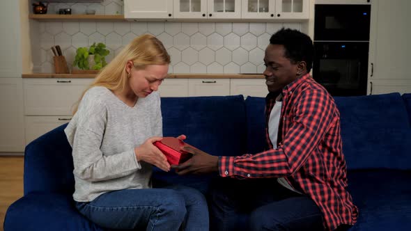 African American Man Boyfriend Gives Gift Box Girlfriend Caucasian Woman Couple alt