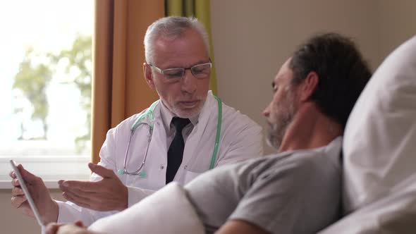 Aging Practitioner Showing MRI Results To Patient alt