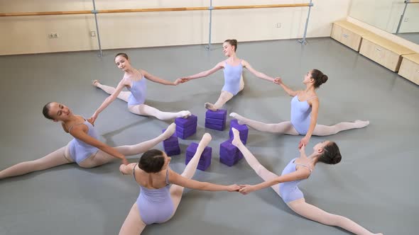 Girls in Ballet Gymnastics Class Practicing Stretching Exercise in a Group alt