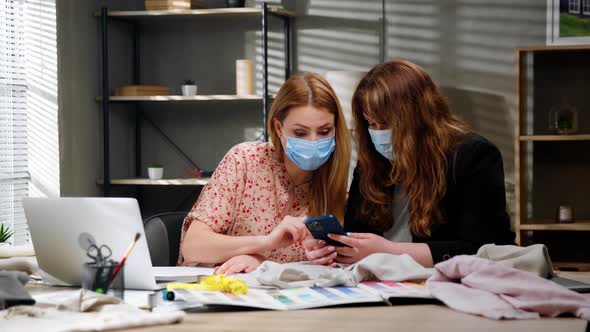 Young Female Professional Fashion Designer Holding Cell Phone Using Ebusiness Applications at alt