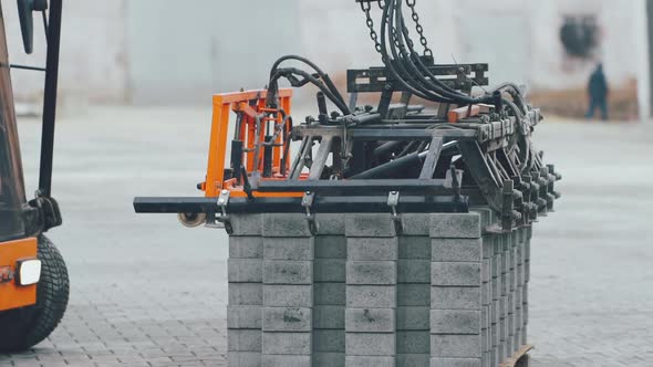 The machine takes part of the gray pavement for further installation
