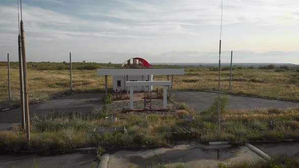 Aerial View of Derelict Gas Station Next To the Road. Abandoned Petrol Station with No Fuel Signs alt