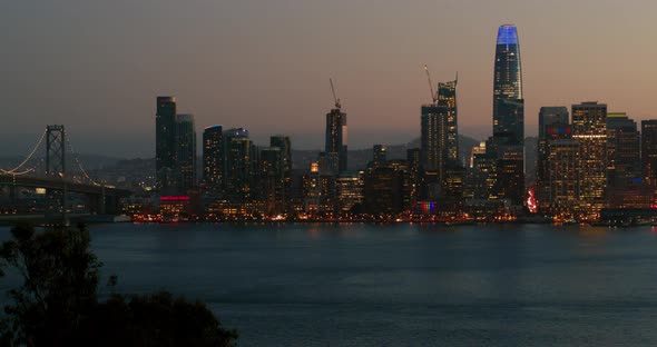 Pedestal Down Shot of San Francisco Skyline and Bay Bridge at Dusk alt