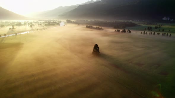 Drone Over Misty Sunlit Landscape Of Zell Am See alt