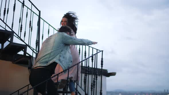 Happy Couple Climbing Stairs Outdoors alt