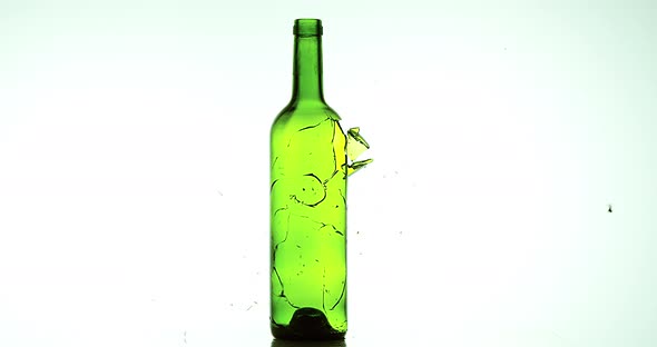 Bottle of Wine Breaking and Exploding against White Background, Slow motion 4K