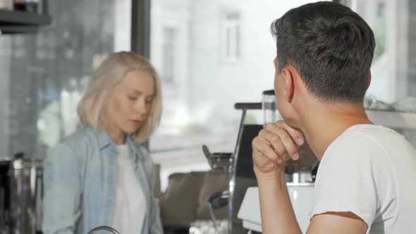 Happy Man Smiling To the Camera After Buying Coffee at the Local Cafe alt