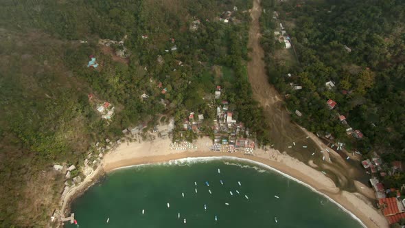 Boats Floating In The Sea With Yelapa Town And Lush Green Forest In The Mountain In Jalisco, Mexico. alt