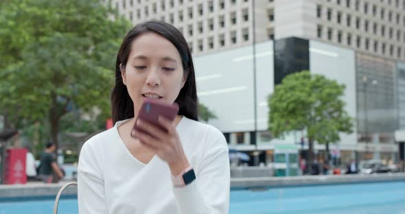 Woman look at mobile phone in Hong Kong alt