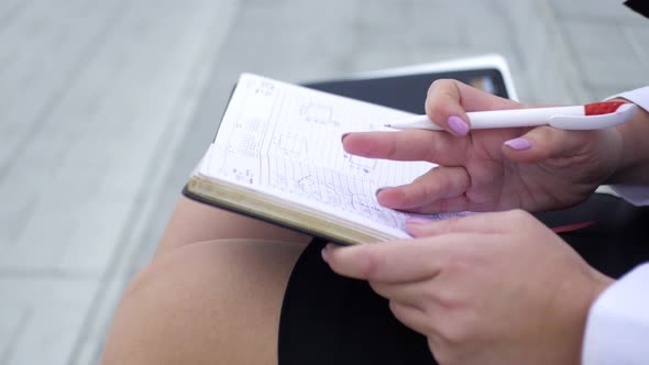 close plan, business woman makes notes in the diary