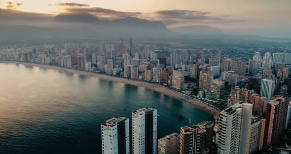 Aerial Cityscape of Buildings on Sea Shore at Sunset in Tourist City Along Beach