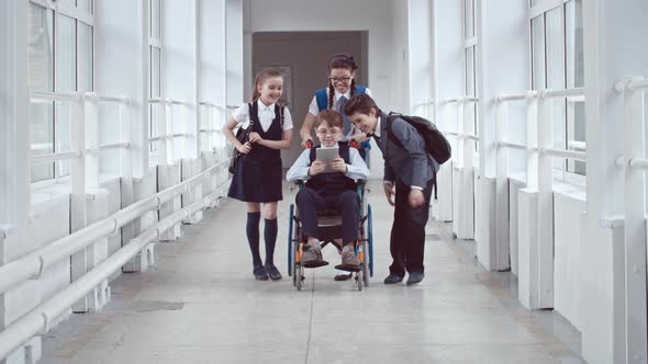 Handicapped Schoolboy Chatting with Friends alt