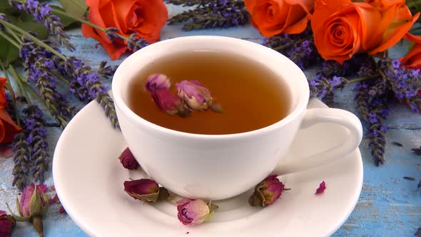 Provencal style composition: tea with fragrant rose buds, fresh rose flowers and lavender  alt