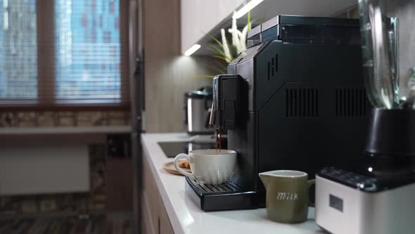 Automatic Coffee Machine Makes a Cup of Morning Coffee alt