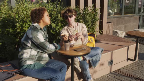 Two Students Having Lunch Outside alt