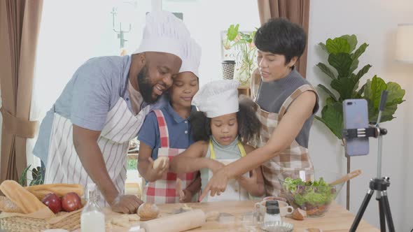 African American family father and mother and children standing and preparing cooking.